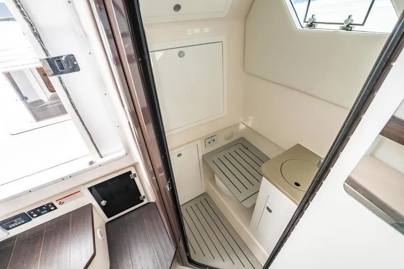 Slide: The Image of 2025 Edgewater 370CC boat interior with compact bathroom and modern amenities. - 16