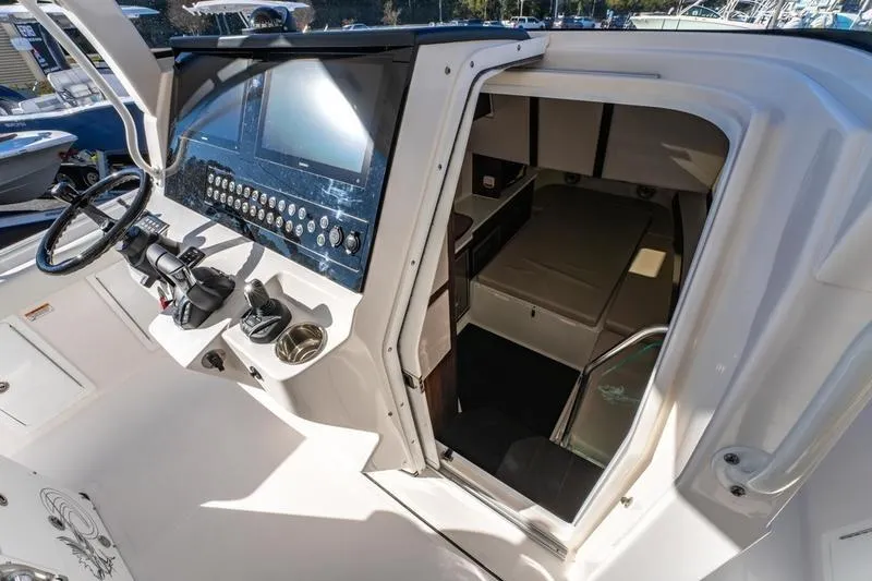 Slide: The Image of 2025 Edgewater 370CC boat interior with helm and cabin view. - 18