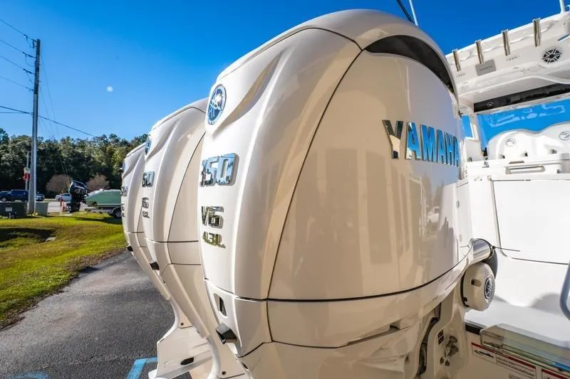 Slide: The Image of 2025 Edgewater 370CC with Yamaha 350 V6 outboard engines, parked outdoors. - 19