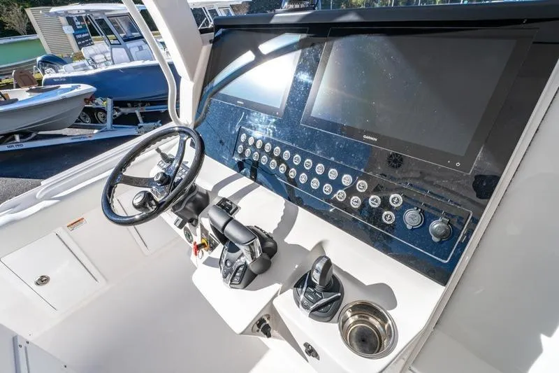 Slide: The Image of Edgewater 370CC 2025 boat dashboard with modern controls and dual screens. - 33