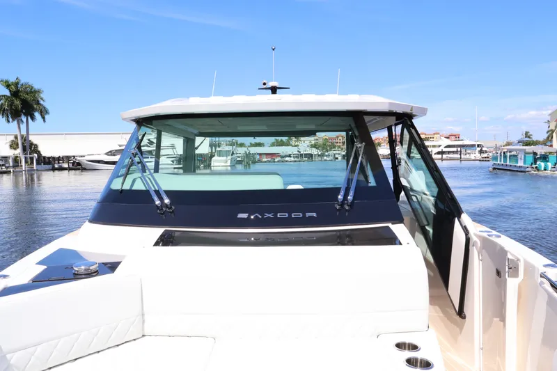 Slide: The Image of Saxdor 400 GTO from 2027 with sleek design, large windows, and luxurious interior by the water. - 48