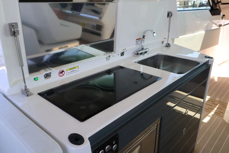 Slide: The Image of The 2027 Saxdor 400 GTO features a modern kitchenette with a sink and cooktop. - 25