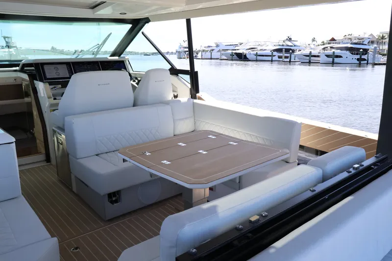 Slide: The Image of The image shows the interior of a 2027 Saxdor 400 GTO with sleek white seating and a wooden table. - 21