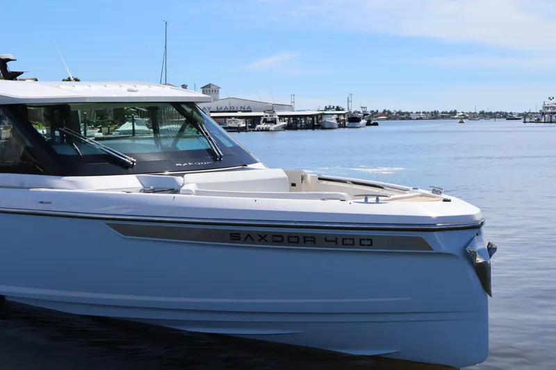 Slide: The Image of A Saxdor 400 GTO boat is in the water near a marina. - 13
