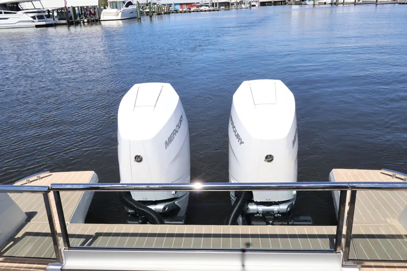 Slide: The Image of Two Mercury outboard engines on a Saxdor 400 GTO, docked on the water. - 15
