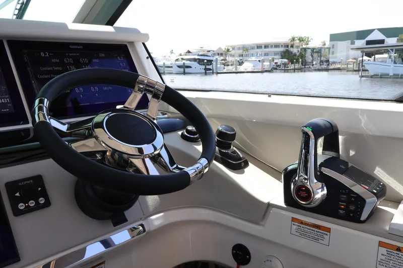 Slide: The Image of The image shows the helm of a Saxdor 400 GTO with modern controls and a view of the marina. - 32