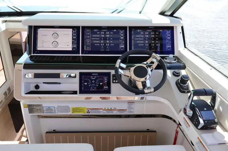 Slide: The Image of The image shows the helm of a 2027 Saxdor 400 GTO with modern instruments and a sleek steering wheel. - 29