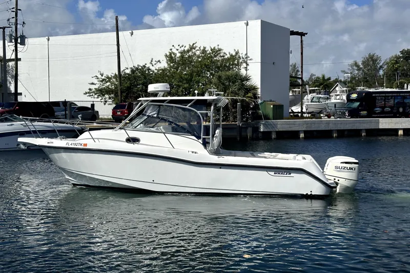 Slide: The Image of 2006 Boston Whaler 285 Conquest boat with Suzuki engine docked in marina. - 15