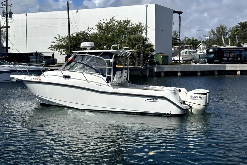 Slide: The Image of 2006 Boston Whaler 285 Conquest boat with Suzuki engine docked in marina. - 16