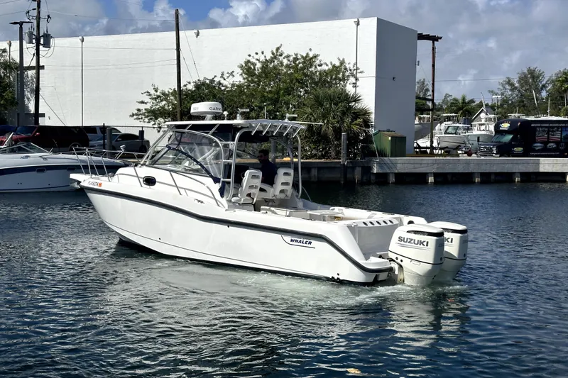 Slide: The Image of 2006 Boston Whaler 285 Conquest boat with Suzuki engines on the water. - 20