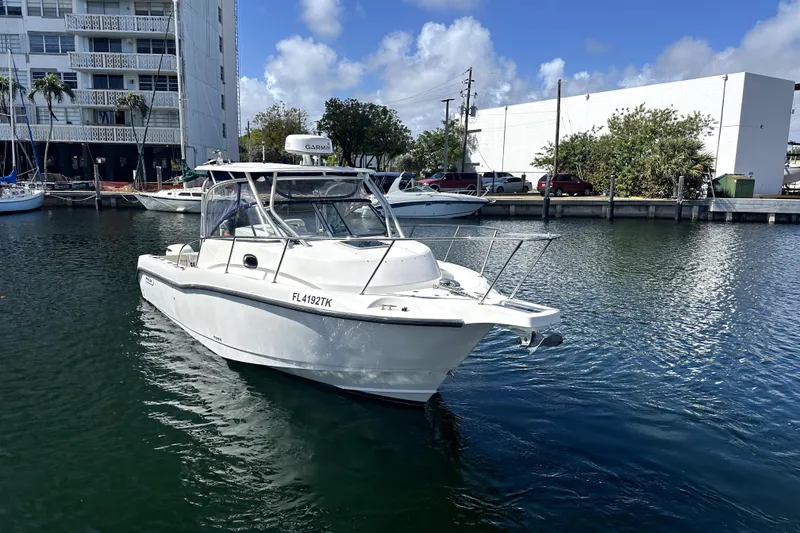 Slide: The Image of 2006 Boston Whaler 285 Conquest boat docked in marina, clear sky background. - 31