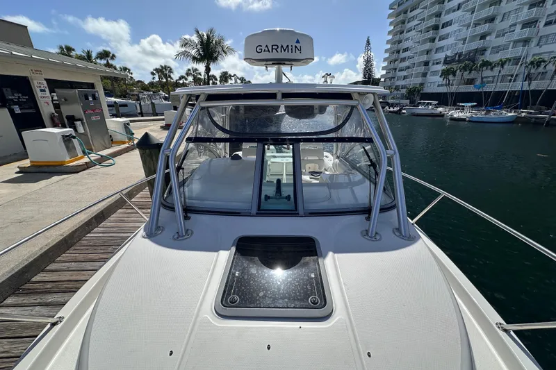 Slide: The Image of 2006 Boston Whaler 285 Conquest docked at marina with Garmin equipment. - 37