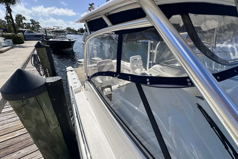 Slide: The Image of 2006 Boston Whaler 285 Conquest docked at marina, clear sunny day. - 38