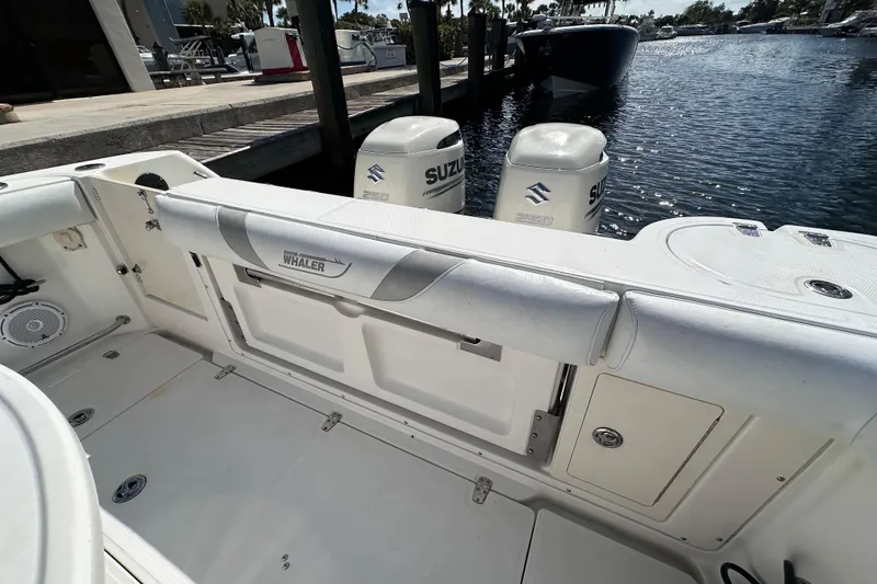 Slide: The Image of 2006 Boston Whaler 285 Conquest boat interior with Suzuki engines at dock. - 45