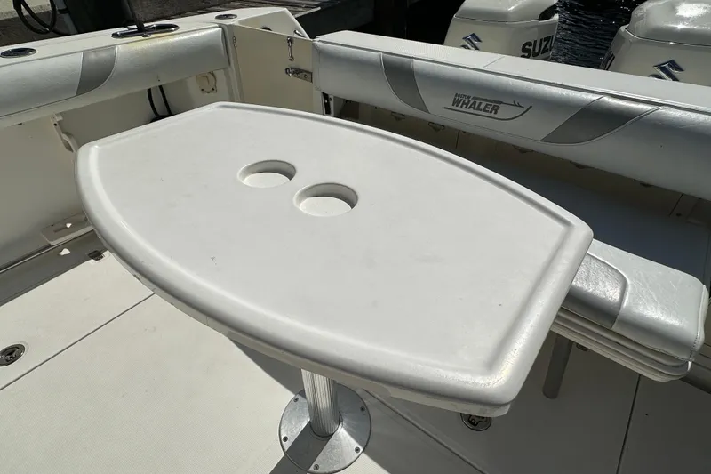 Slide: The Image of 2006 Boston Whaler 285 Conquest boat interior with table and seating. - 47