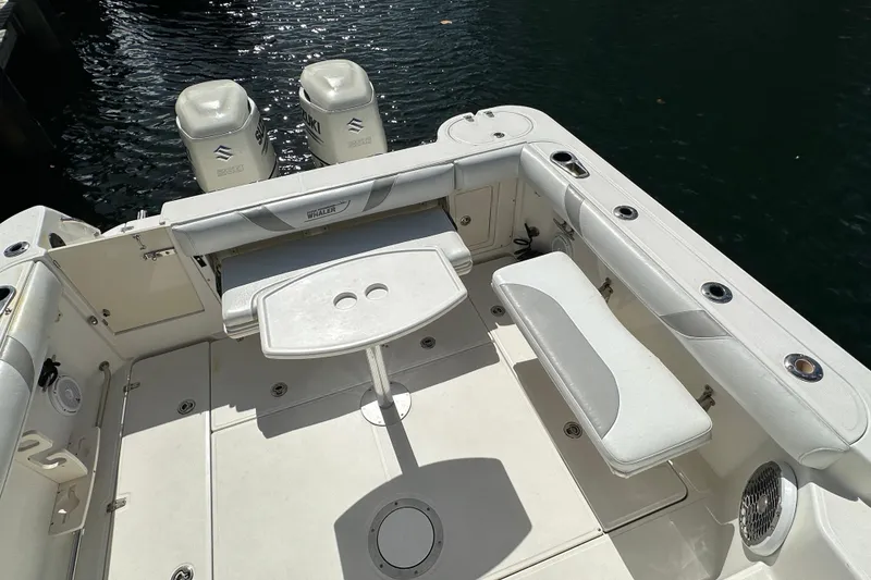 Slide: The Image of 2006 Boston Whaler 285 Conquest boat deck with seating and twin engines. - 50