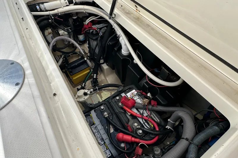Slide: The Image of 2006 Boston Whaler 285 Conquest engine compartment with visible wiring and battery setup. - 52