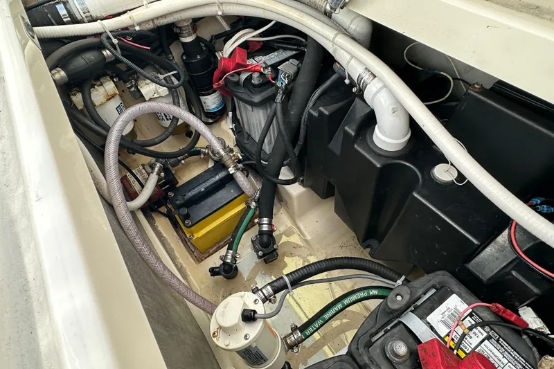 Slide: The Image of Engine compartment of a 2006 Boston Whaler 285 Conquest, showcasing wiring and components. - 53