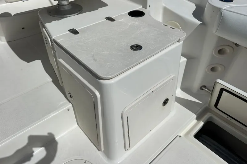 Slide: The Image of 2006 Boston Whaler 285 Conquest boat interior with storage compartments and seating. - 56