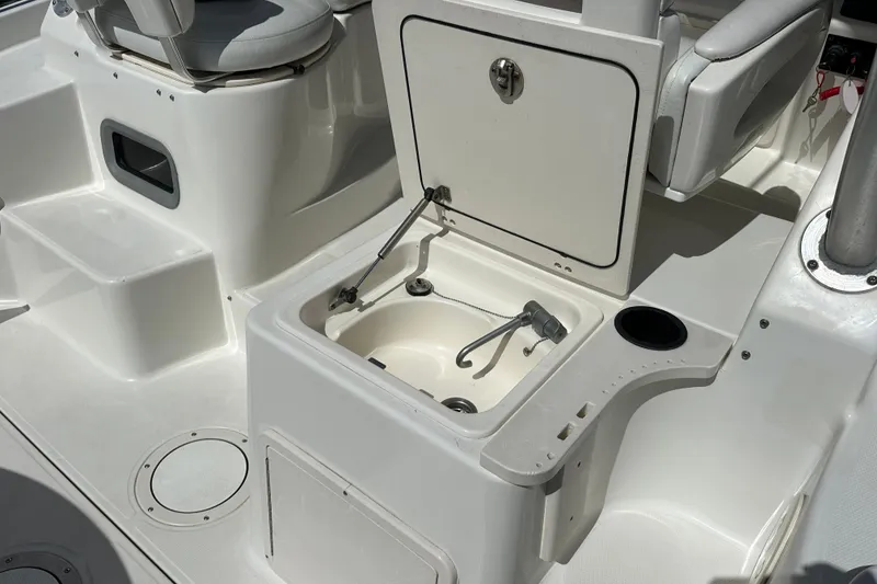 Slide: The Image of 2006 Boston Whaler 285 Conquest boat interior with open storage compartment and seating. - 57