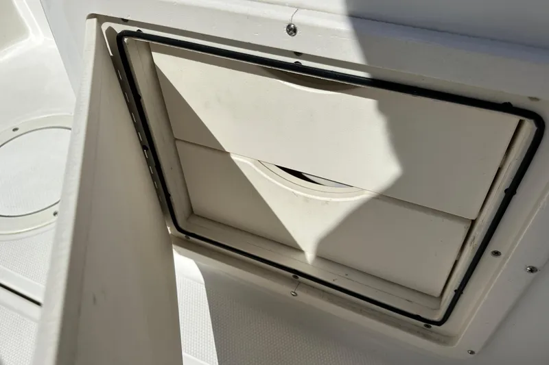 Slide: The Image of 2006 Boston Whaler 285 Conquest storage compartment detail, open hatch view. - 58