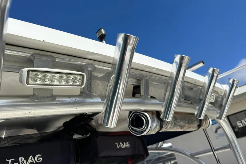 Slide: The Image of Boston Whaler 285 Conquest 2006 boat rod holders and LED lights under clear blue sky. - 62