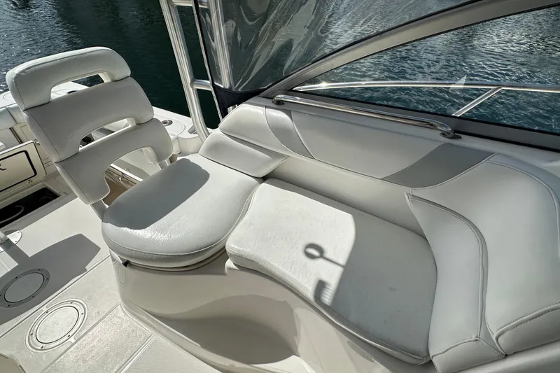 Slide: The Image of 2006 Boston Whaler 285 Conquest boat interior with white cushioned seating. - 63