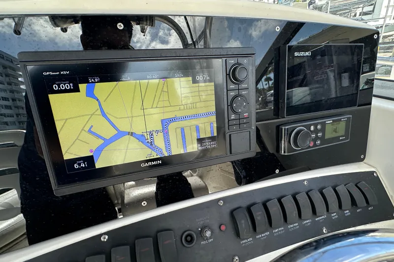 Slide: The Image of Dashboard of 2006 Boston Whaler 285 Conquest with Garmin GPS and Suzuki controls. - 65