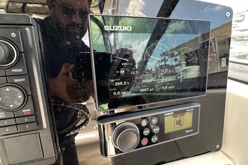 Slide: The Image of Control panel of a 2006 Boston Whaler 285 Conquest boat with Suzuki display. - 66