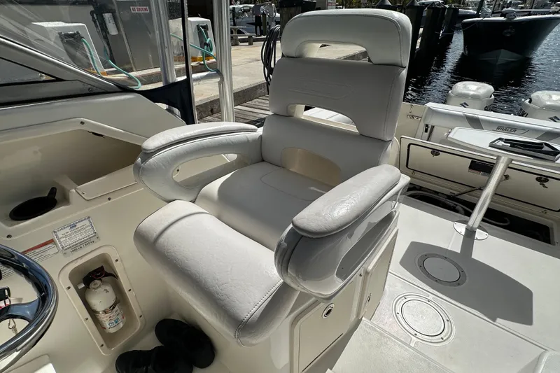 Slide: The Image of Captain's chair on 2006 Boston Whaler 285 Conquest boat, docked at marina. - 67