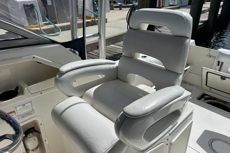 Slide: The Image of Captain's chair on 2006 Boston Whaler 285 Conquest boat, docked at marina. - 68