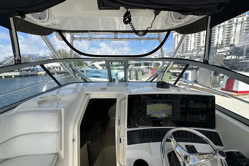 Slide: The Image of 2006 Boston Whaler 285 Conquest helm with navigation system, docked at marina. - 70