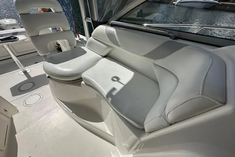 Slide: The Image of 2006 Boston Whaler 285 Conquest boat interior with cushioned seating and helm chair. - 72