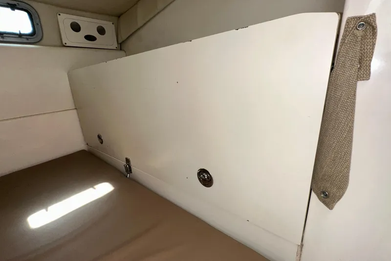 Slide: The Image of Interior cabin of 2006 Boston Whaler 285 Conquest boat, featuring storage compartment. - 79