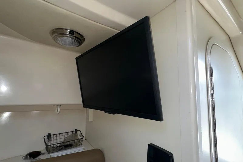 Slide: The Image of Interior of 2006 Boston Whaler 285 Conquest with mounted TV and storage basket. - 83