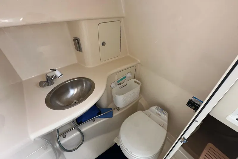 Slide: The Image of 2006 Boston Whaler 285 Conquest bathroom with sink and toilet. - 84