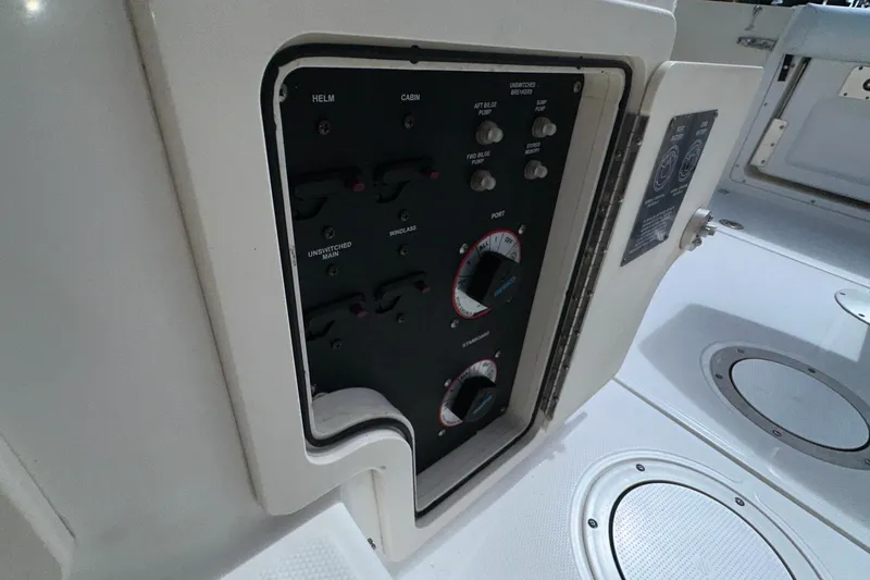 Slide: The Image of Control panel on a 2006 Boston Whaler 285 Conquest boat, featuring various switches and dials. - 86