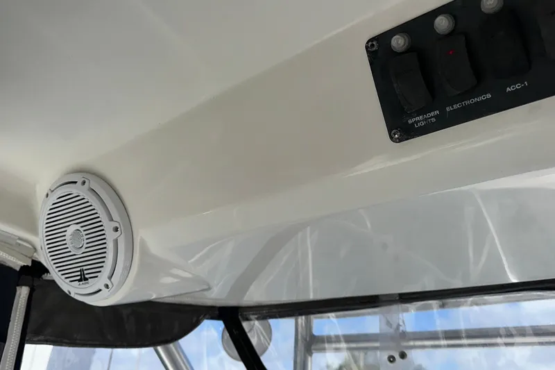 Slide: The Image of Interior view of a 2006 Boston Whaler 285 Conquest boat with speaker and control panel. - 90