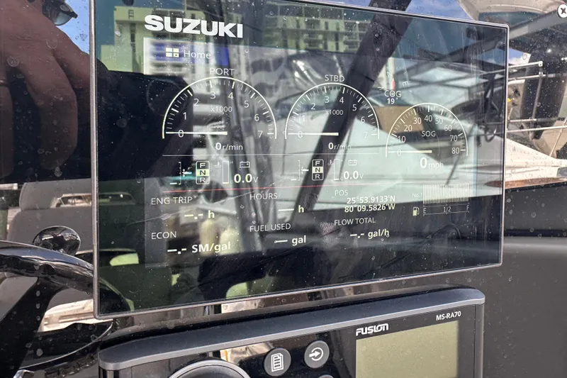 Slide: The Image of Suzuki dashboard on 2006 Boston Whaler 285 Conquest boat, displaying engine and navigation data. - 91