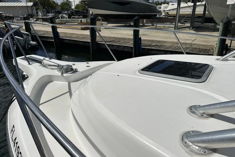 Slide: The Image of 2006 Boston Whaler 285 Conquest boat docked, showcasing deck and railing details. - 92