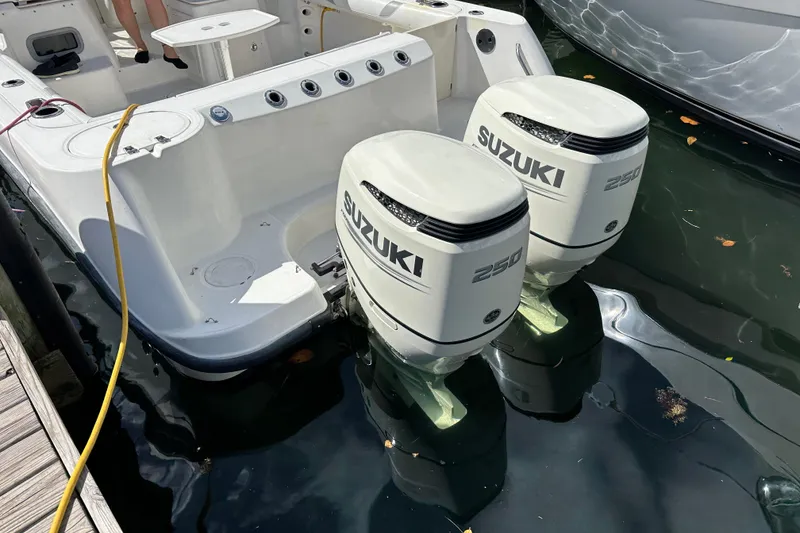 Slide: The Image of 2006 Boston Whaler 285 Conquest with twin Suzuki 250 outboard engines docked. - 94