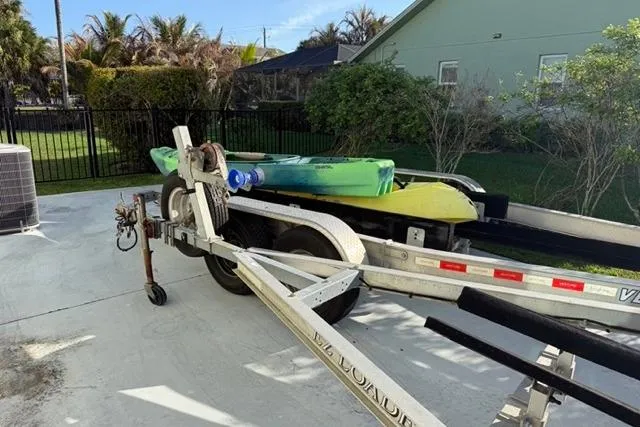 Slide: The Image of Trailer with kayaks beside a 2007 Pathfinder 2200 Tournament Edition boat. - 16