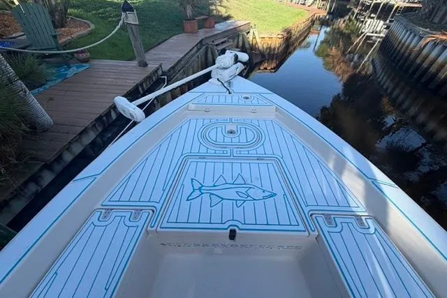 Slide: The Image of 2007 Pathfinder 2200 Tournament Edition boat docked by a canal, featuring custom deck design. - 2