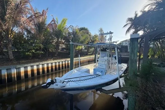 Slide: The Image of 2007 Pathfinder 2200 Tournament Edition boat docked by palm trees in a canal. - 3