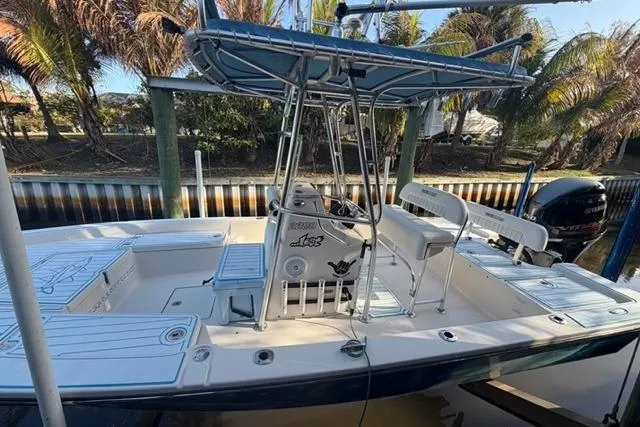 Slide: The Image of 2007 Pathfinder 2200 Tournament Edition boat docked near palm trees. - 4