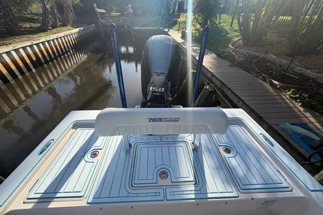 Slide: The Image of 2007 Pathfinder 2200 Tournament Edition boat with Yamaha 150 engine in a canal setting. - 7