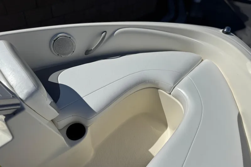 Slide: The Image of 2006 Bayliner 175 XT boat interior with white seating and speaker detail. - 11