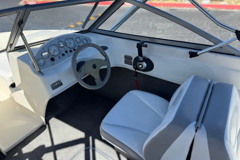 Slide: The Image of Interior of a 2006 Bayliner 175 XT boat, featuring steering wheel and dashboard controls. - 21