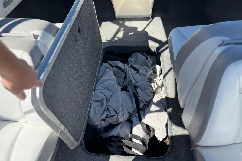 Slide: The Image of 2006 Bayliner 175 XT boat storage compartment with gray cover inside. - 24