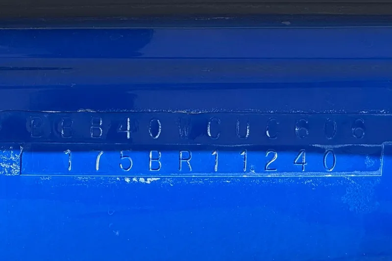 Slide: The Image of 2006 Bayliner 175 XT boat hull identification number on blue surface. - 28